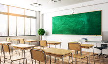 a classroom with brown chairs and a green chalk board in the front
